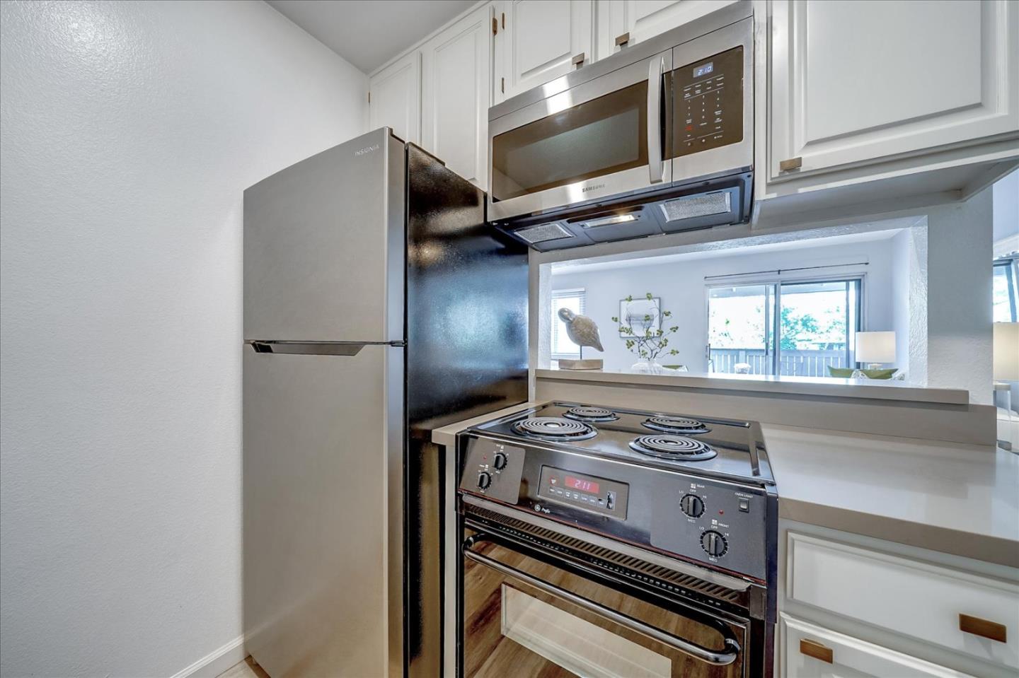 1126 Cherry Avenue, Unit 16 San Bruno, CA 94066 - Photo 8 of 32 a kitchen with a stove and a microwave