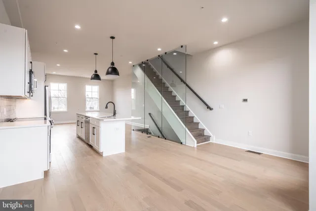 a view of kitchen and hall with wooden floor