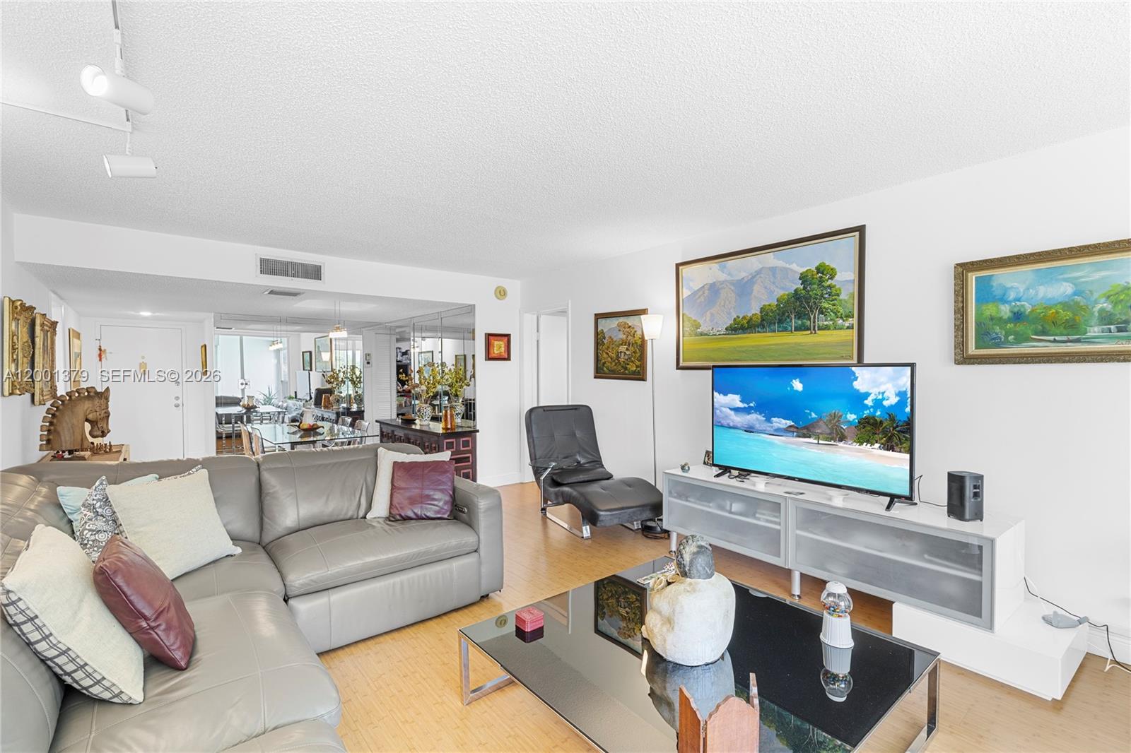 16251 Golf Club Road, Unit 311 Weston, FL 33326 - Photo 21 of 38 a living room with furniture and a flat screen tv