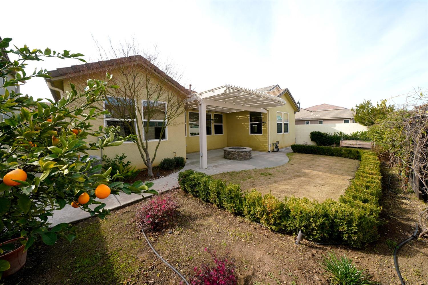3563 Journey Way Clovis, CA 93619 - Photo 17 of 20 a front view of house with yard and trees around