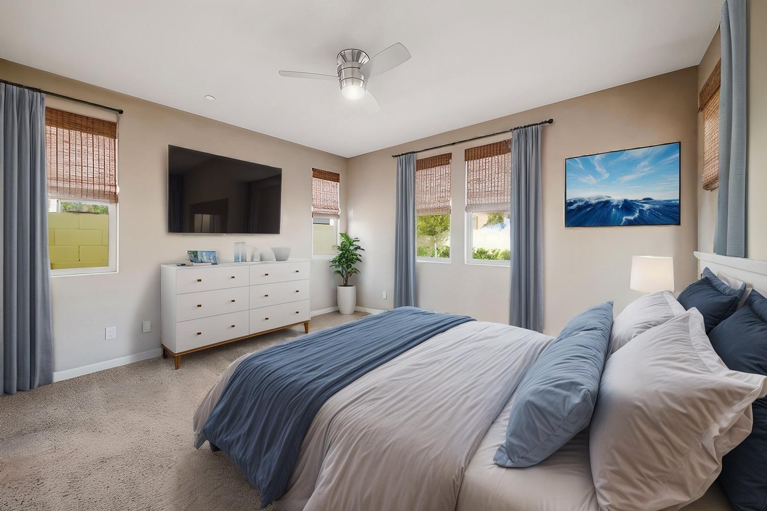 3563 Journey Way Clovis, CA 93619 - Photo 9 of 20 a bedroom with a bed and a flat screen tv