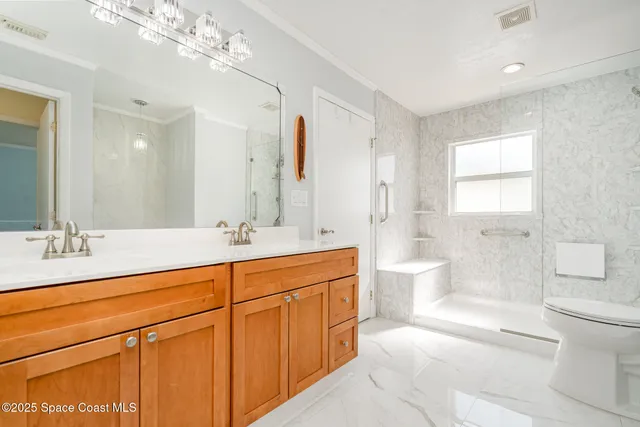 a spacious bathroom with double vanity a toilet a a mirror a bathtub and shower