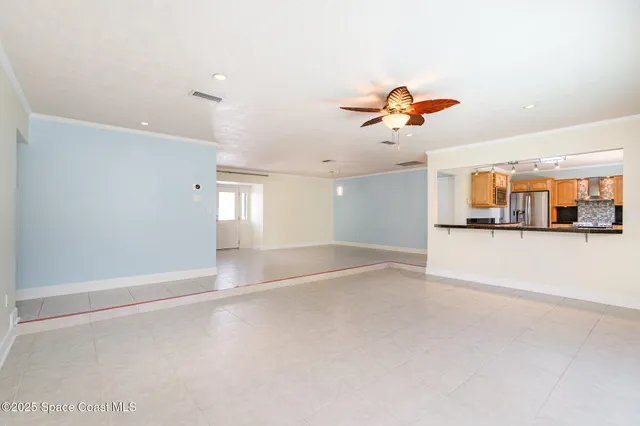 an empty room with a view of a kitchen