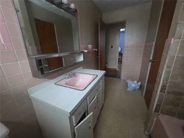 a bathroom with a sink a toilet and a shower