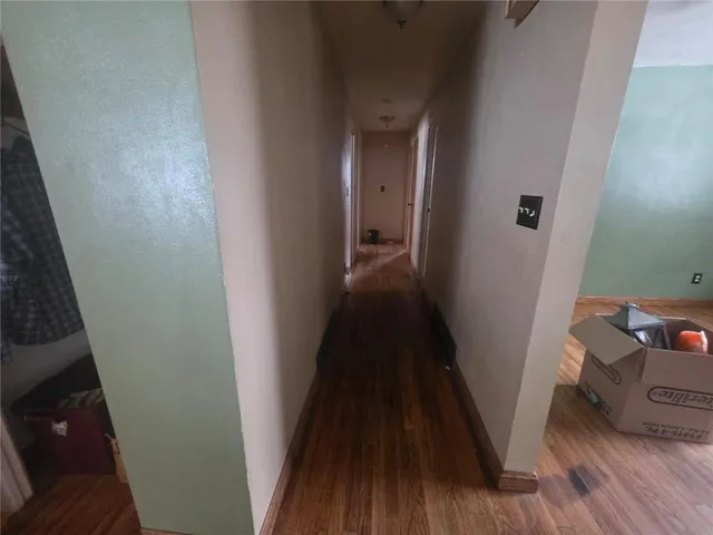 a view of a hallway and wooden floor