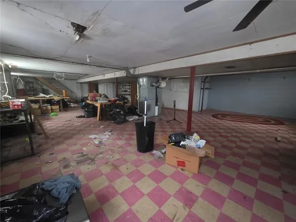 a living room with furniture and a gym machine