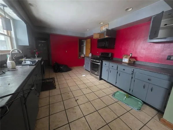 a kitchen with stainless steel appliances kitchen island granite countertop a sink stove and cabinets
