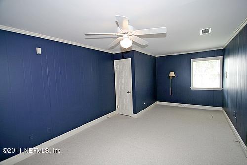 12316 Mandarin Road Jacksonville, FL 32223 - Photo 23 of 40 an empty room with windows and fan