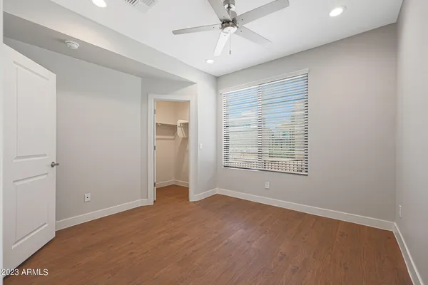 a view of empty room with wooden floor