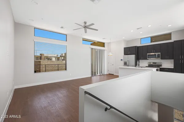 a view of kitchen with stainless steel appliances refrigerator oven and cabinets