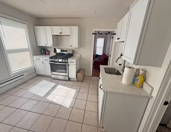 a kitchen with a sink appliances and cabinets