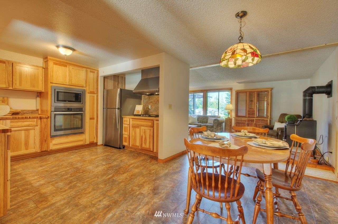 2138 Union Avenue Northeast Renton, WA 98059 - Photo 4 of 23 a dining room filled chandelier and wooden floor