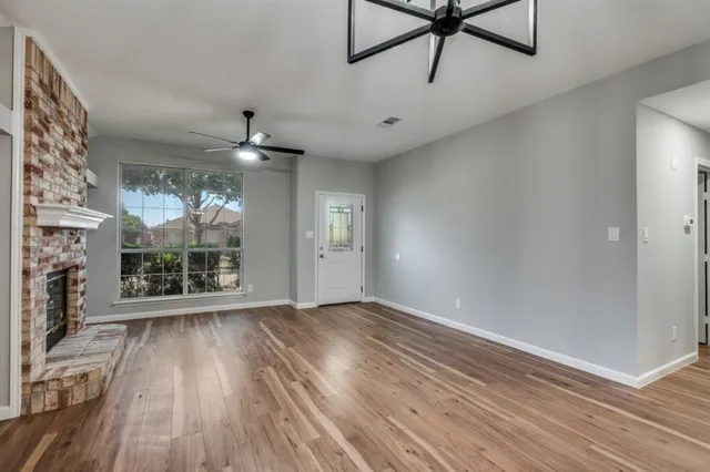 wooden floor in an empty room with a window