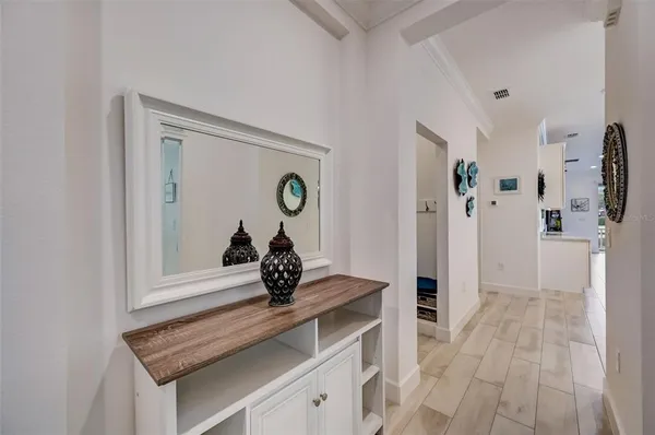 a kitchen with kitchen island granite countertop a table chairs microwave and cabinets