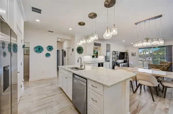 a view of kitchen with cabinets table and chairs