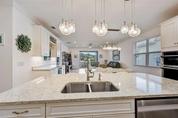 a view of a dining room with furniture and chandelier