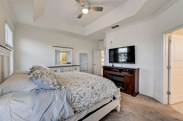 a bedroom with a bed and a chandelier