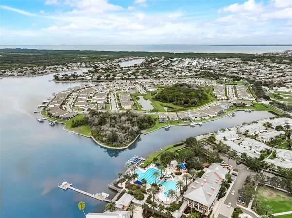 a vase with flowers sitting on a floor next to a window