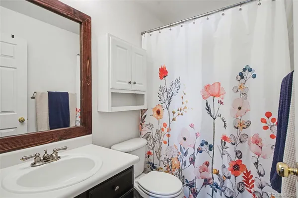 a bathroom with a sink toilet and a mirror