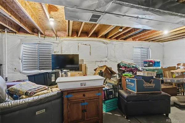 a storage room with furniture and a flat screen tv
