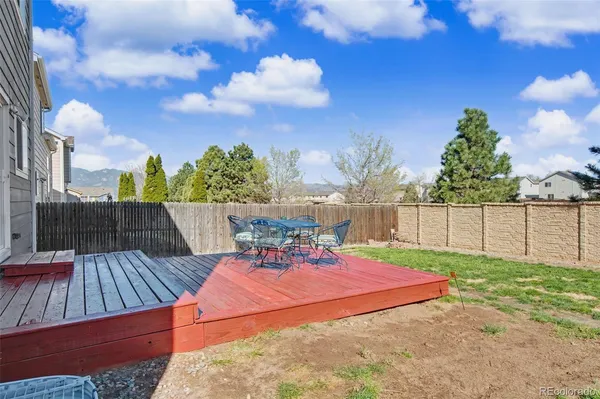 a view of a backyard with sitting area