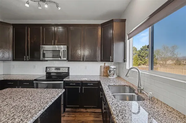 a kitchen with a stove sink and microwave