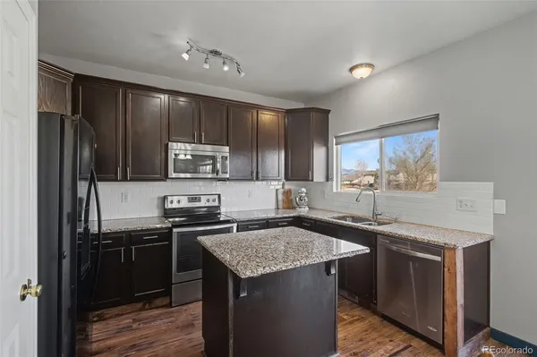a kitchen with a sink stove and refrigerator