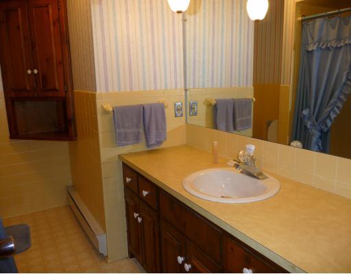 10440 Five Points Road Home, PA 15747 - Photo 7 of 12 Other. Full bath has large vanity with laundry shoot, ceramic and papered walls, tub/shower combination as seen in mirror, commode and corner cupboard. Also, light with exhaust fan in ceiling.
