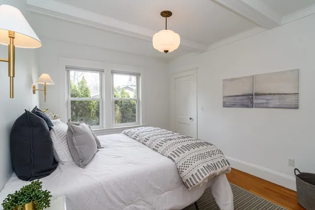 a bedroom with a bed window and wall painting