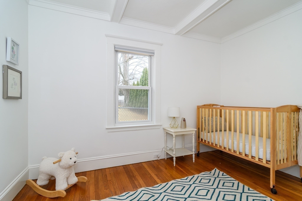 32 Harvard Street Natick, MA 01760 - Photo 16 of 24 a view of an empty room with a window and wooden floor