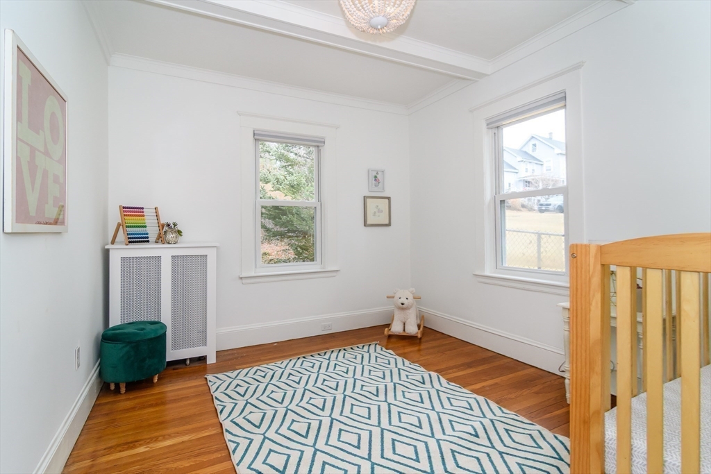 32 Harvard Street Natick, MA 01760 - Photo 17 of 24 a bedroom with furniture and a window