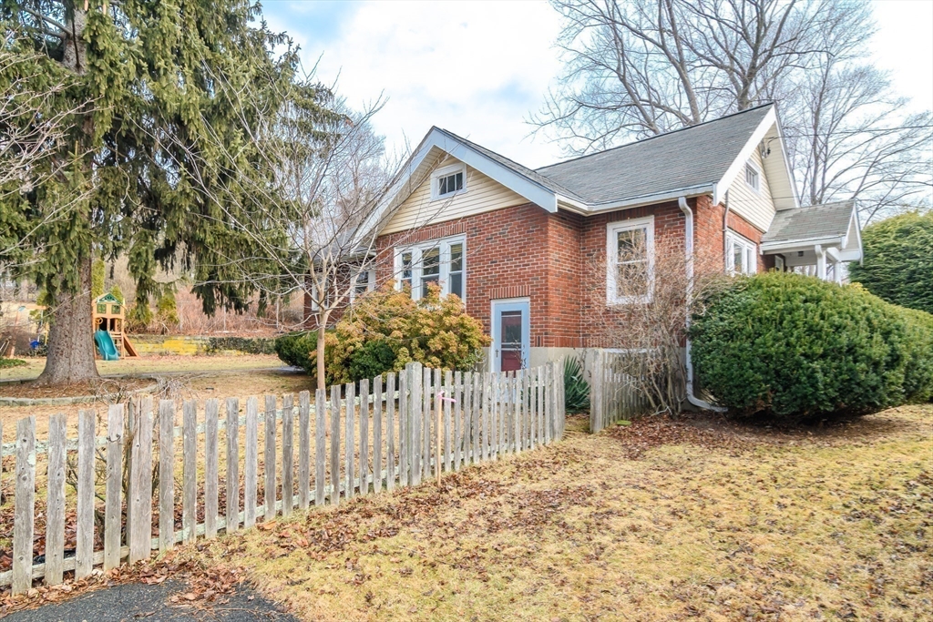 32 Harvard Street Natick, MA 01760 - Photo 23 of 24 a front view of a house with a yard and garage