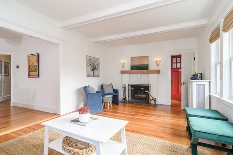 a living room with fireplace furniture and a wooden floor
