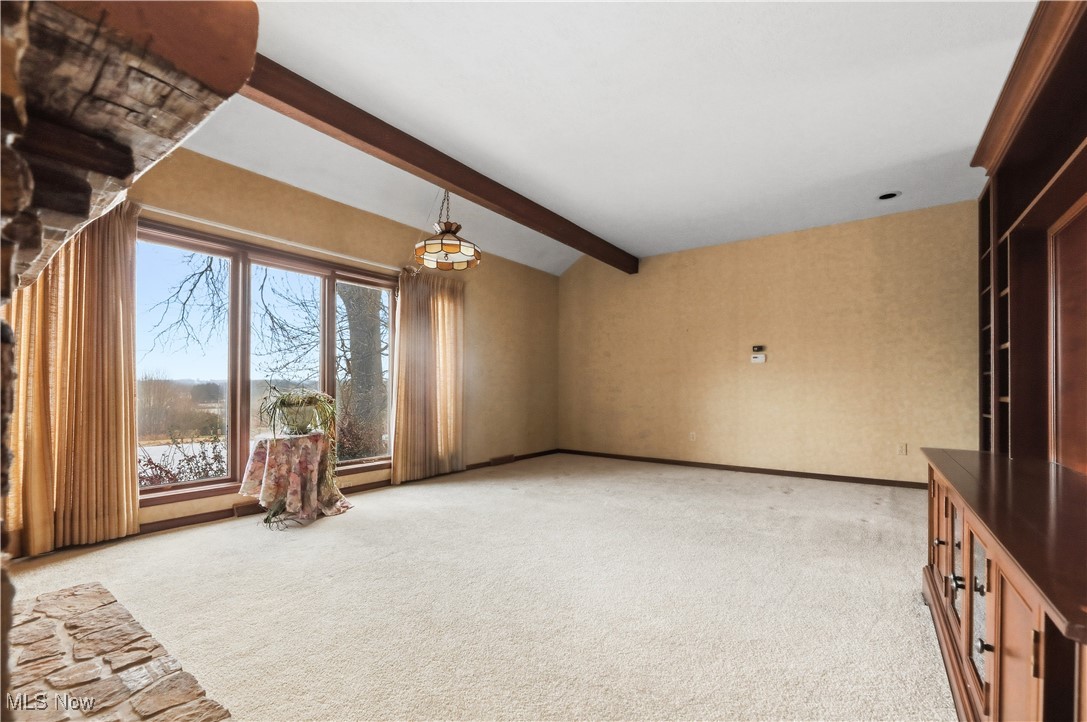7014 River Styx Road Medina, OH 44256 - Photo 8 of 49 Unfurnished living room featuring light carpet and a chandelier