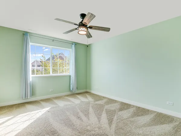 a view of a bedroom with a ceiling fan and a chandelier fan