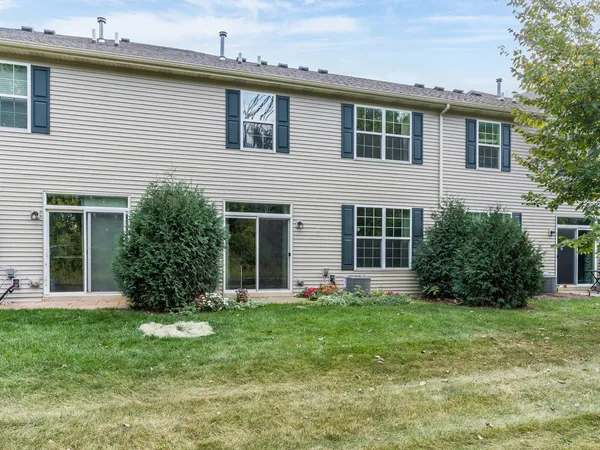 a view of a house with a yard and sitting space