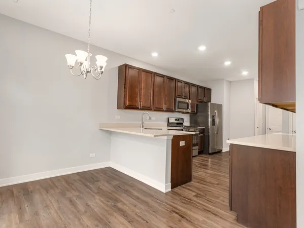 a kitchen with stainless steel appliances granite countertop a refrigerator stove and oven