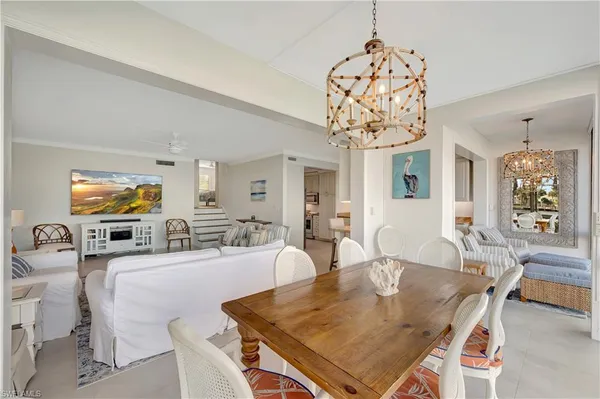a view of a dining room with furniture and chandelier
