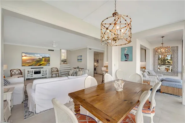 a view of a dining room with furniture and chandelier