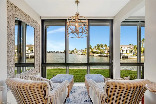a balcony with furniture and a floor to ceiling window