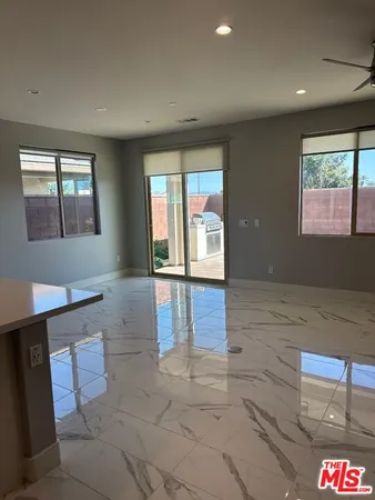 a room with a wooden floor and potted plant
