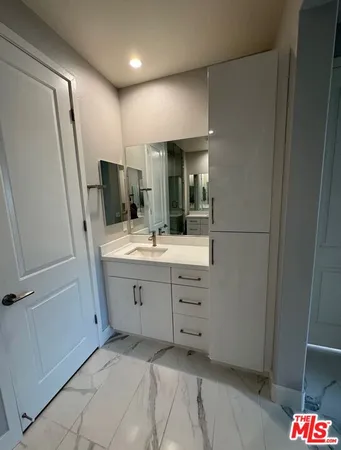 a bathroom with a shower sink and mirror