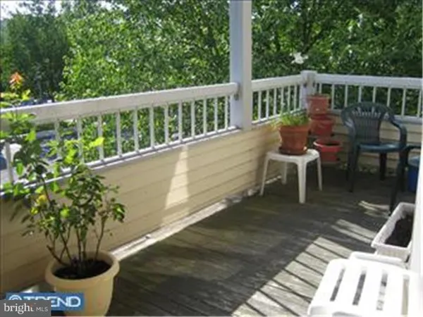 a view of a chairs and table on the wooden deck