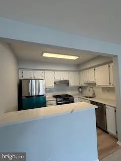 a kitchen with stainless steel appliances a stove sink and cabinets