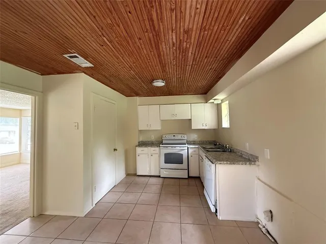a kitchen with a stove a sink and a refrigerator