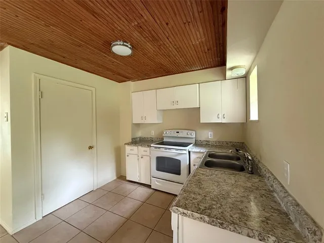 a kitchen with a stove a sink and a refrigerator
