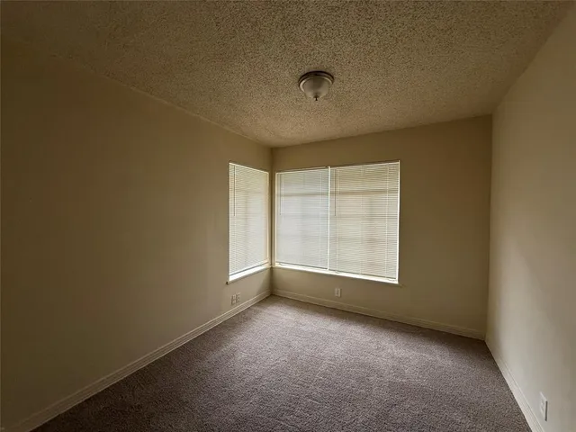 an empty room with a empty space and windows