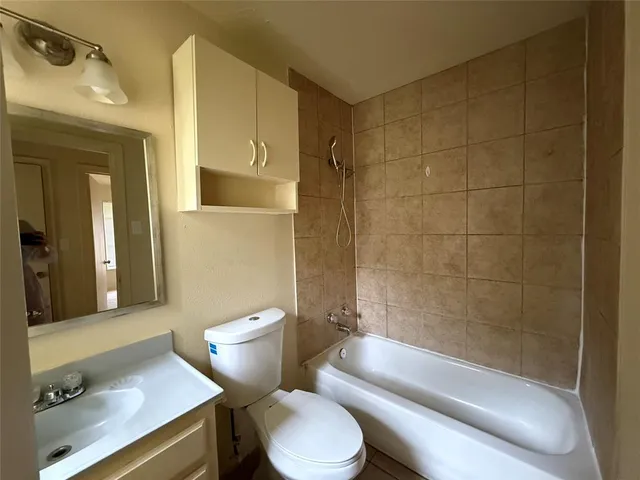a bathroom with a toilet a sink and bathtub