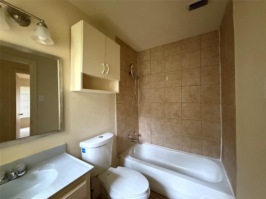 4748 South Ridge Terrace Fort Worth, TX 76133 - Photo 10 of 15 a bathroom with a sink a toilet and shower