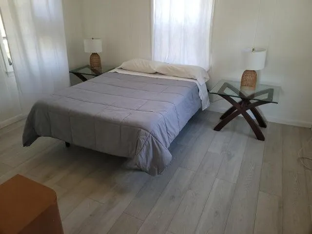 a bedroom with a bed and a stool
